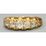 Yellow metal five stone diamond ring, the graduated brilliant cut diamonds in claw settings, on