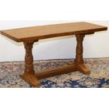 Robert Mouseman Thompson of Kilburn - an oak coffee table, rectangular adzed top on octagonal
