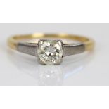 18ct yellow and white gold solitaire ring, the round cut diamond in white gold claw setting, on