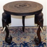 C20th Indian hardwood occasional table, circular top carved with figures in geometric and floral