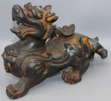 C20th Chinese patinated and parcel gilt bronze model of a Kylin, L29cm H18cm
