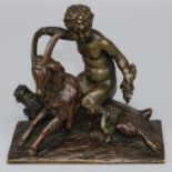 After the Antique - a small patinated bronze model of a faun with grape bunch astride a goat, on