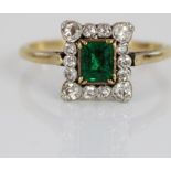 18ct yellow gold and platinum cluster ring, the central emerald cut emerald in claw setting,