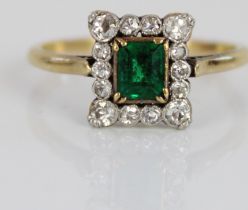 18ct yellow gold and platinum cluster ring, the central emerald cut emerald in claw setting,