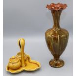 Linthorpe pottery mustard yellow glazed three piece cruet, trefoil base with pierced handle,