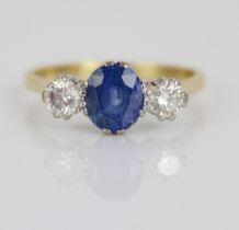 18ct yellow gold sapphire and diamond three stone ring, the central oval cut sapphire flanked by two