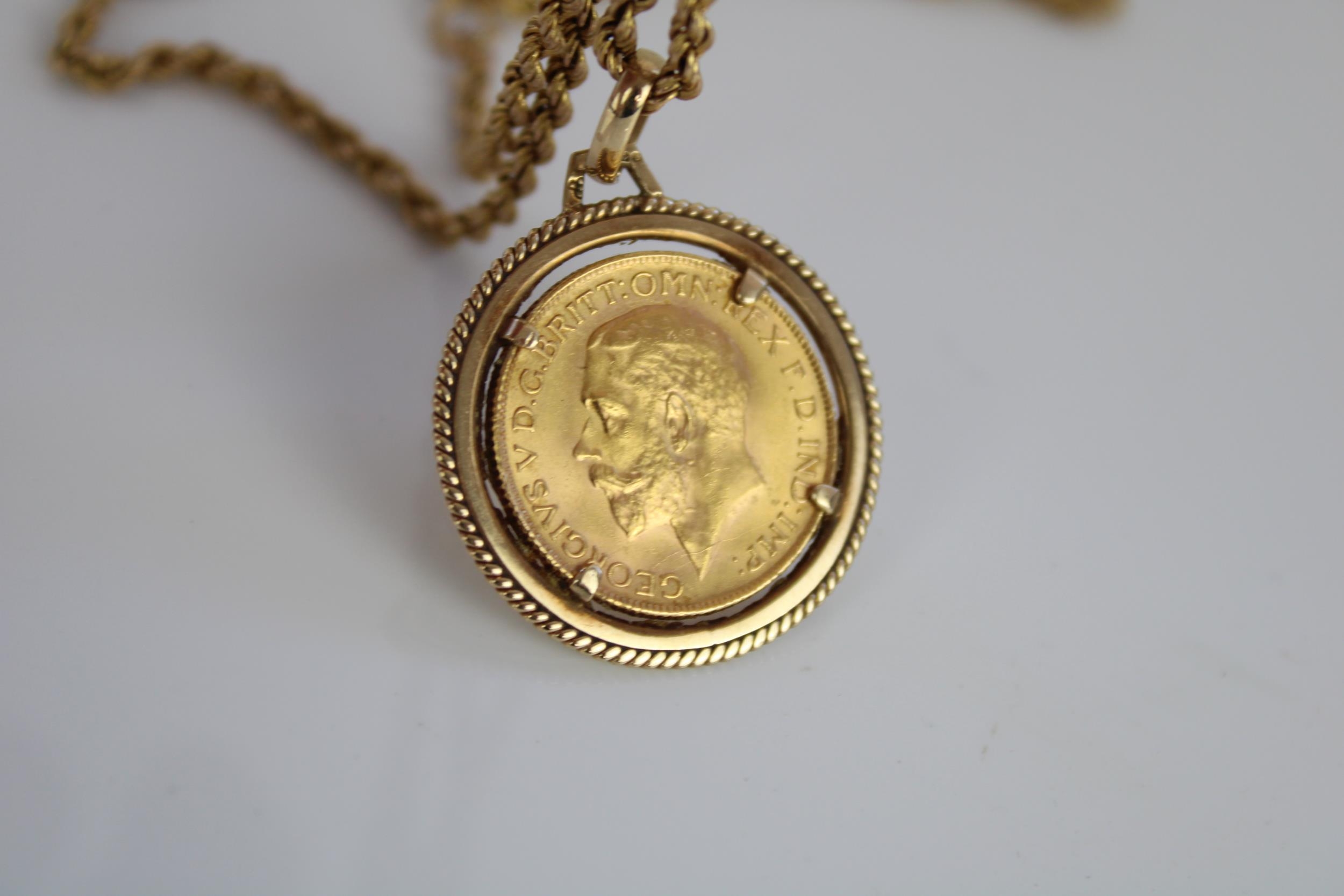 Geo.V 1928 sovereign in 9ct yellow gold mount, stamped 375, on 9ct yellow gold rope twist chain, - Image 2 of 2