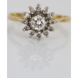 18ct yellow gold diamond floral cluster ring, the large central diamond surrounded by a halo of