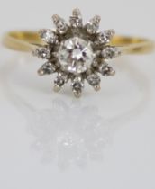 18ct yellow gold diamond floral cluster ring, the large central diamond surrounded by a halo of