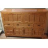Derek Fishman Slater of Crayke - an panelled adzed oak side cabinet with two fall fronts, three