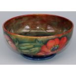 Moorcroft Pottery: Anemone pattern footed bowl, tubelined decoration of red and orange flowers on