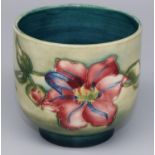Moorcroft Pottery: Clematis pattern cache pot, tubelined decoration of pink and blue flowers on