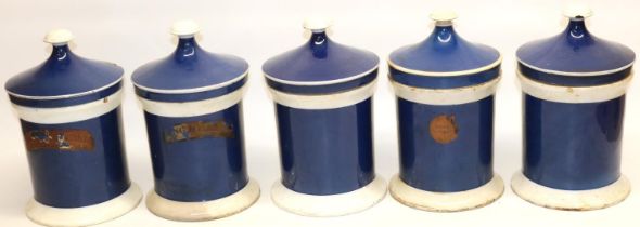 Five Apothecary or Chemists blue and white ceramic jars and covers, some remains of old paper labels