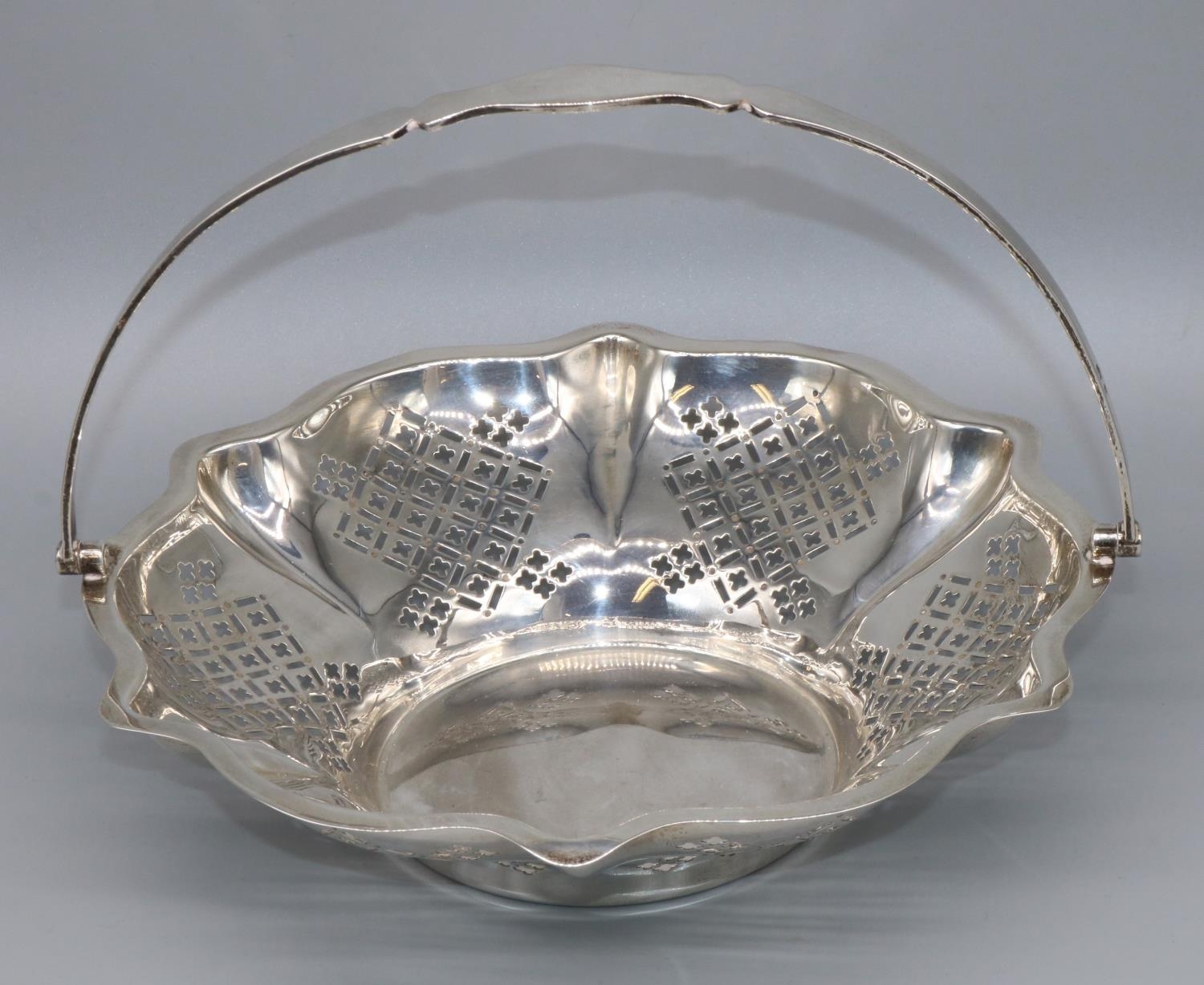 George V hallmarked silver circular cake basket, with geometrically pierced tapering sides and