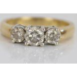 18ct yellow gold three stone diamond ring, the central brilliant cut diamond flanked by two