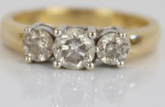 18ct yellow gold three stone diamond ring, the central brilliant cut diamond flanked by two