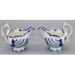 Two C18th Derby porcelain blue and white dolphin ewer shape cream jugs, with dolphin and trident
