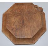 Robert Mouseman Thompson of Kilburn - an oak octagonal teapot stand, carved with signature mouse,