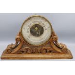 Victorian brass cased circular Aneroid barometer, in leaf scroll carved and pierced oak stand