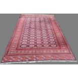 Bokhara pattern multi coloured carpet, elephants foot medallion field in repeating hooked