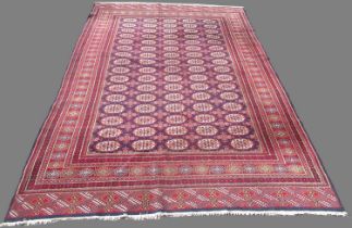 Bokhara pattern multi coloured carpet, elephants foot medallion field in repeating hooked