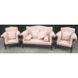 George 111 style serpentine back sofa and two arm chairs, the gadrooned mahogany frame carved with