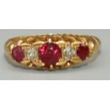 18ct yellow gold five stone ruby and diamond ring, the three round cut rubies separated by two