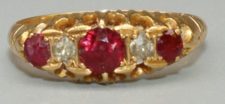 18ct yellow gold five stone ruby and diamond ring, the three round cut rubies separated by two