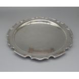 George V hallmarked silver circular salver with raised Chippendale style border, by Cooper