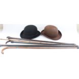 Two Bowler hats and a selection of canes and walking sticks (qty)