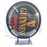 Large outdoor wall mounted Guinness advertising sign, metal rim and hardwearing plastic front and