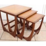 1970s G-Plan Astro nest of three teak tables on curved supports, max H50cm