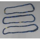 Three single row lapis lazuli beaded necklaces with yellow metal screw clasps, all 47cm