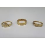 9ct yellow gold Claddagh ring, size R, a 9ct ring in the form of a belt, size N, and a 9ct gold band