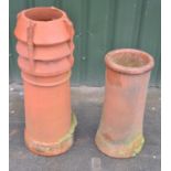 Fluted and a barrel terracotta chimney pot, and a gun barrel pot (2)