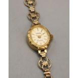 Victor lady's gold cased quartz wristwatch, signed champangne dial with applied baton hour