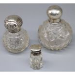 Three C20th cut glass scent bottles with various hallmarked silver tops, Birmingham Chester 1906-