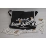 Ten Marshall white script name plates for amplifiers and a branded Marshall bag