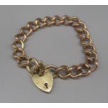 Yellow metal charm bracelet, unmarked, with 9ct yellow gold heart padlock, stamped 375, 22.3g