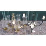 Brass four branch chandelier with glass storm type shades, and a wrought metal verdigris finish