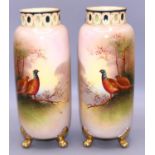 Pair of Fieldings Crown Devon cylindrical vases, decorated with pheasants by J Coleman, raised on