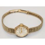 Accurist lady's 9ct gold hand wound wristwatch, signed sunburst silvered dial with applied baton
