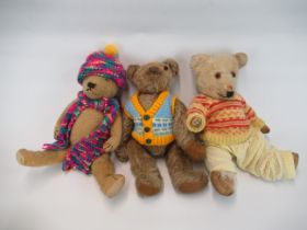 Three early C20th British teddy bears in knitted outfits