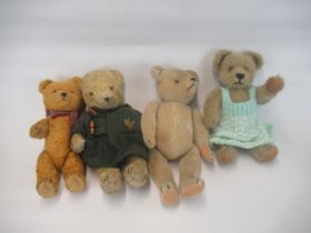 Four early C20th and later British teddy bears, one in a green duffel coat