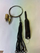 Vintage leather game carrier with metal carrying loop, .22 wrist bullet bracelet, and two brass