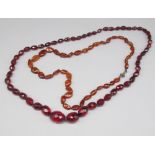 Amber necklace with silver clasp, L54cm, stamped 925, and a red plastic beaded necklace