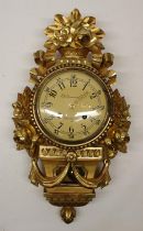 E.C. Qvarnstrom Stockholm - C20th Empire style gilt wall clock, the case embellished with garlands