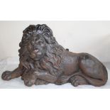 Victorian black painted iron hearth ornament, cast as a recumbent lion, W68cm H35cm