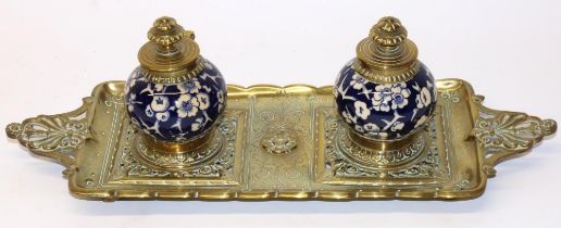 Late C19th brass inkstand, fitted with twin globular porcelain wells decorated with blue and white