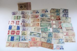 Wad of all world banknotes together with a small booklet of Far East banknotes incl. Hong Kong,